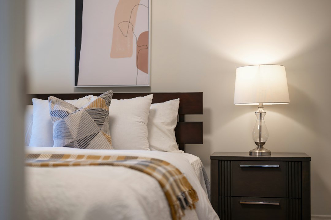 A cozy bedroom with a lit bedside lamp